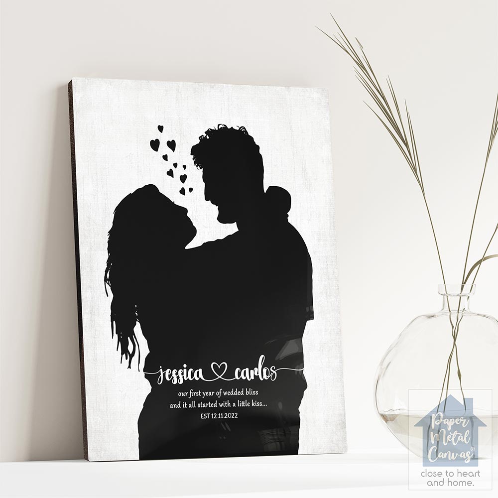 Relocation concept. A smiling cheerful multiracial couple in embraces lookin in each other eyes Relocation concept. A smiling cheerful multiracial couple in embraces lookin in each other eyes