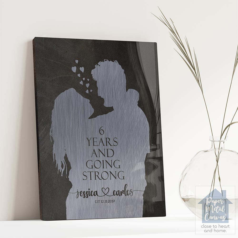 Relocation concept. A smiling cheerful multiracial couple in embraces lookin in each other eyes Relocation concept. A smiling cheerful multiracial couple in embraces lookin in each other eyes